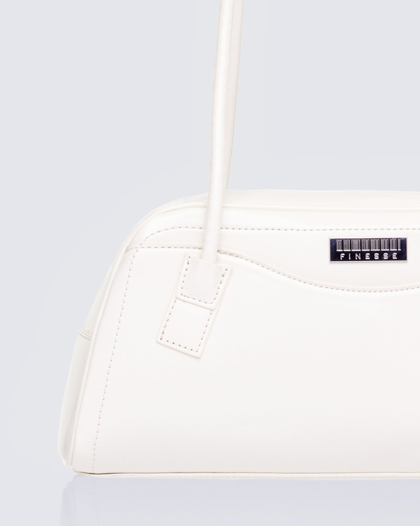 White shoulder bag styled on model – FINESSE