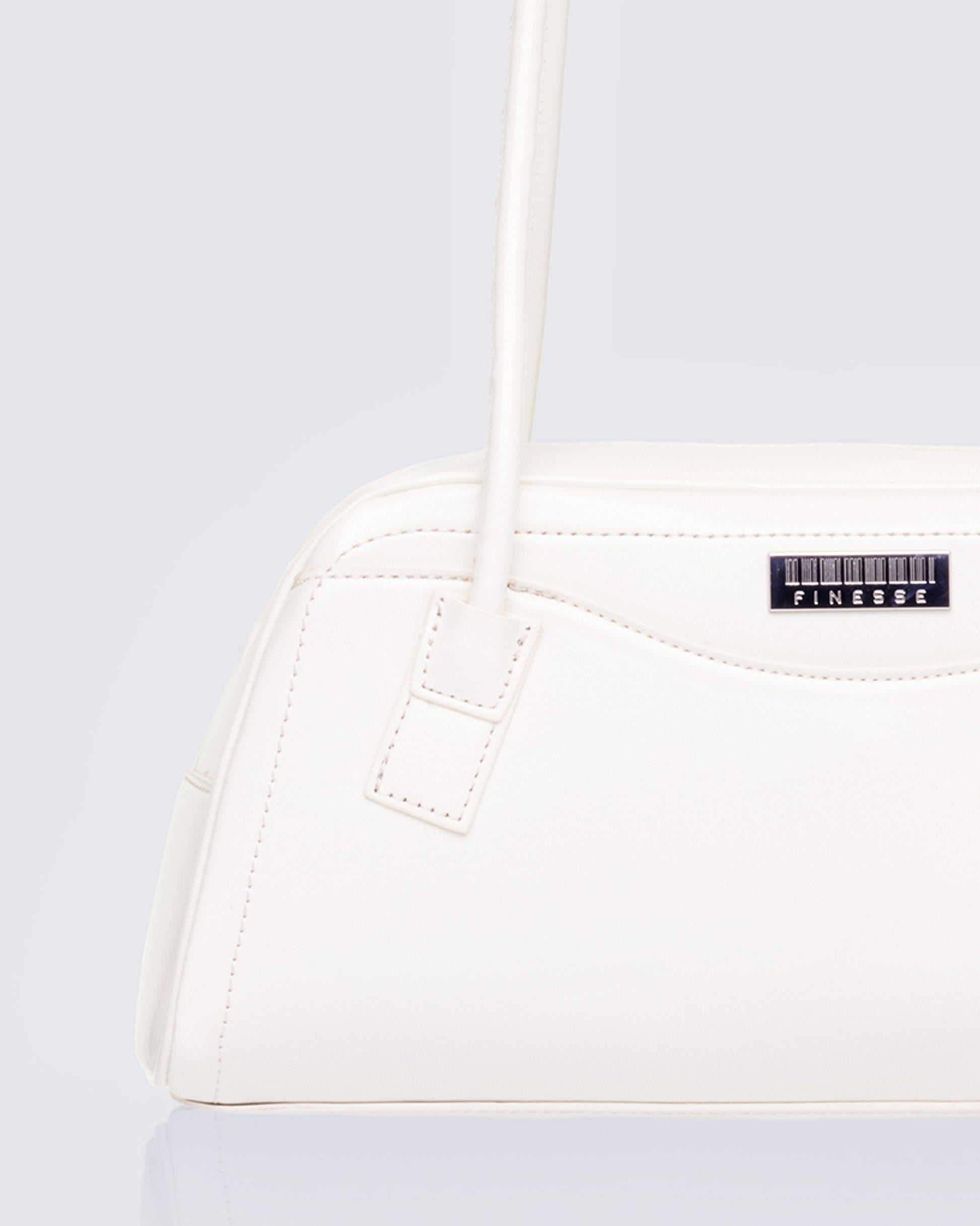White shoulder bag styled on model – FINESSE